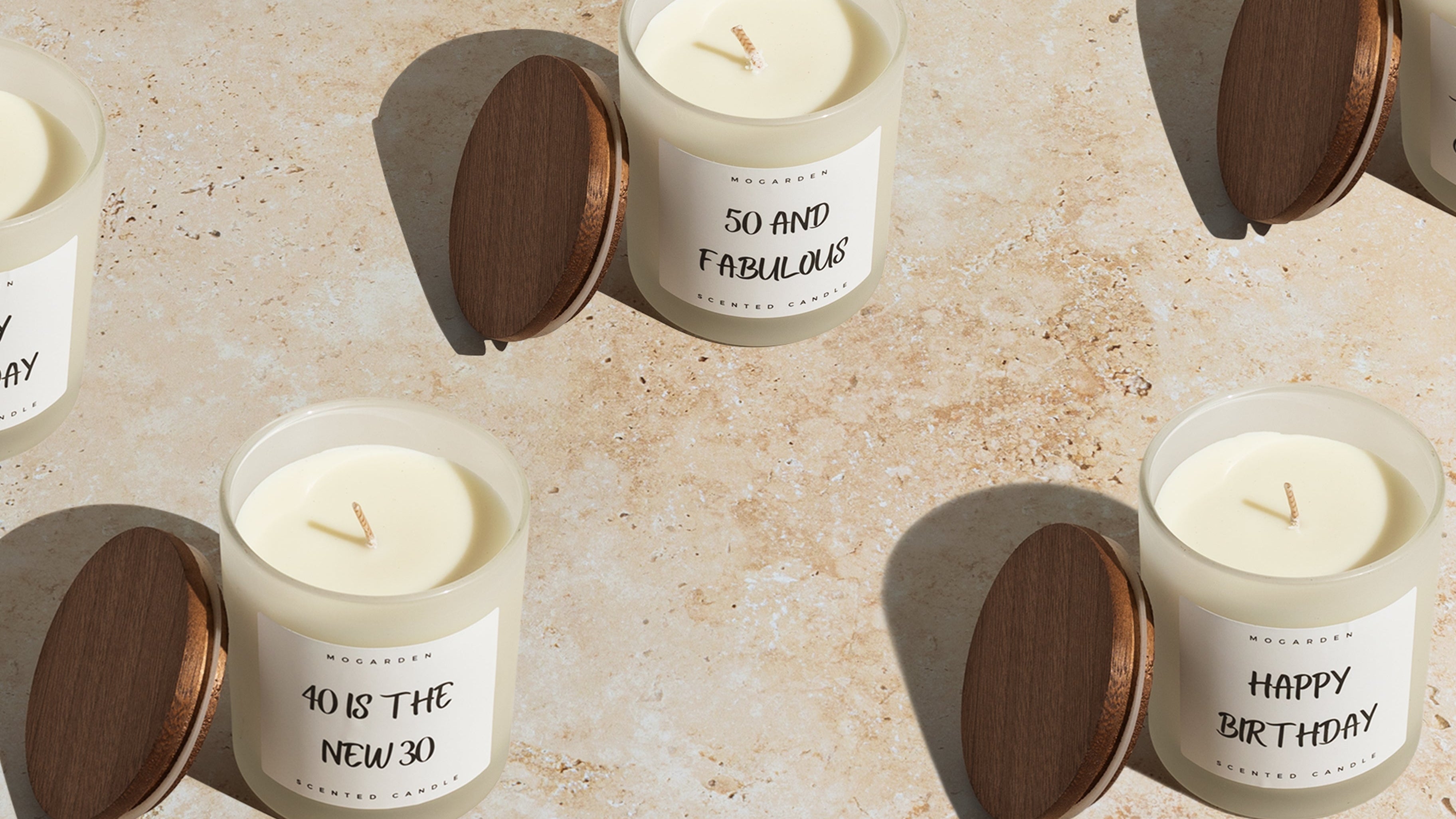 Candles with humorous labels on a textured surface